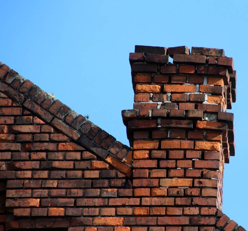 Signs Your Cone Home Needs a Chimney Inspection Damaged chimney on an Cone home showing cracks and missing mortar